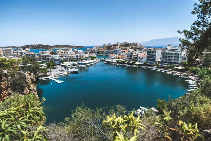 Scenic view of a coastal secondary city with a calm marina.