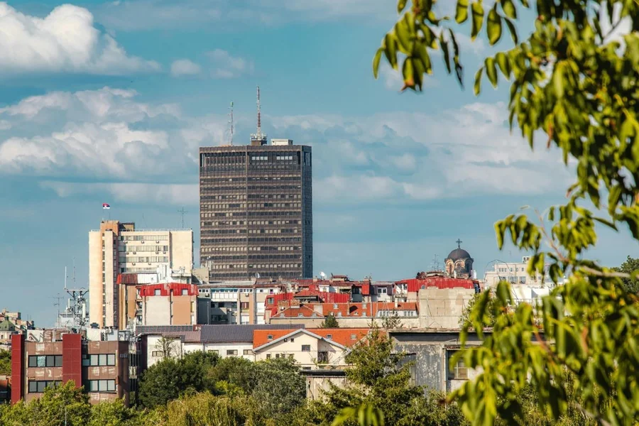 Skyline of a secondary city with modern and historic buildings, reflecting why wealthy people are quietly moving to secondary cities.